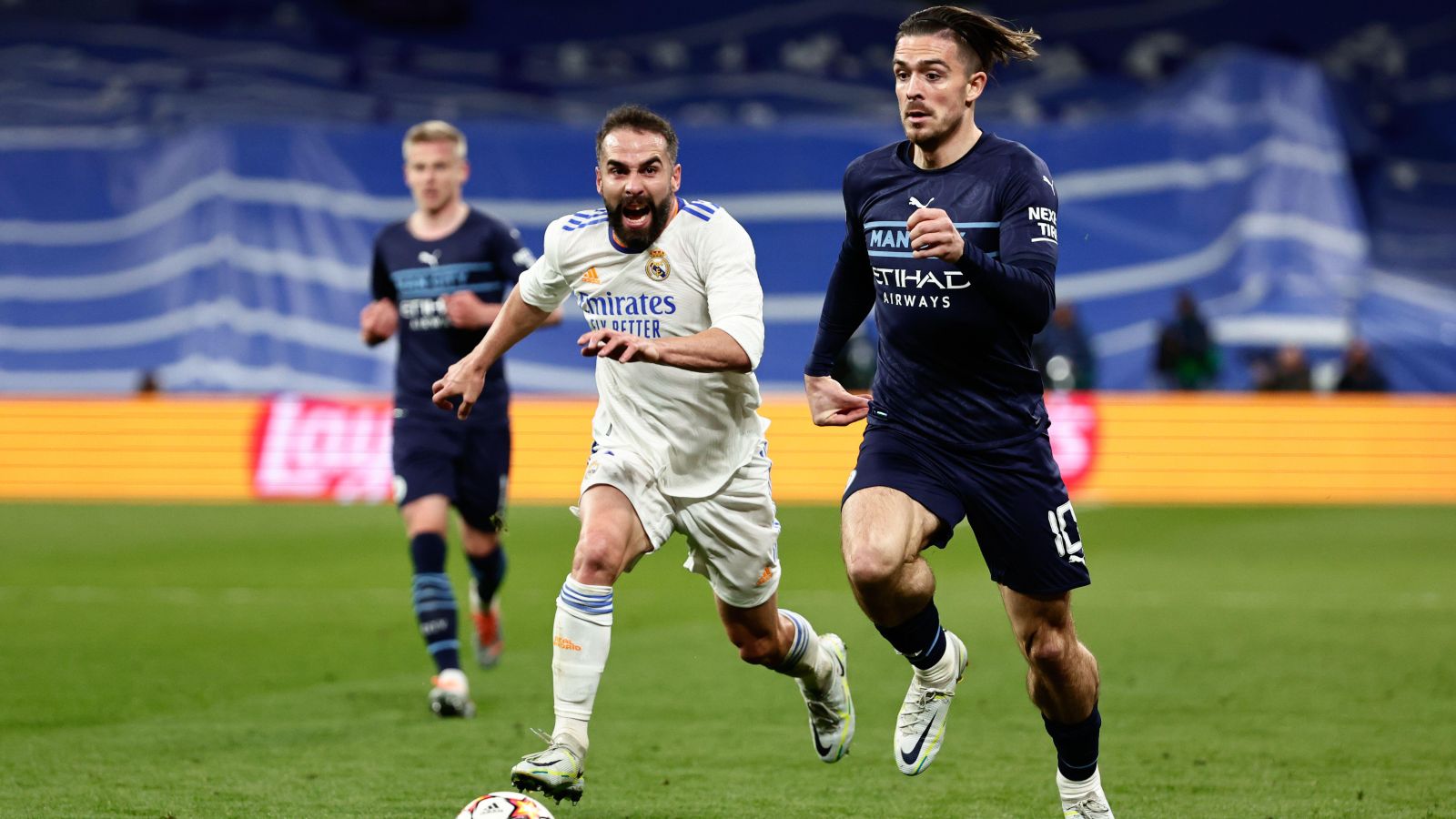 Man City star Jack Grealish runs away from a Real Madrid defender