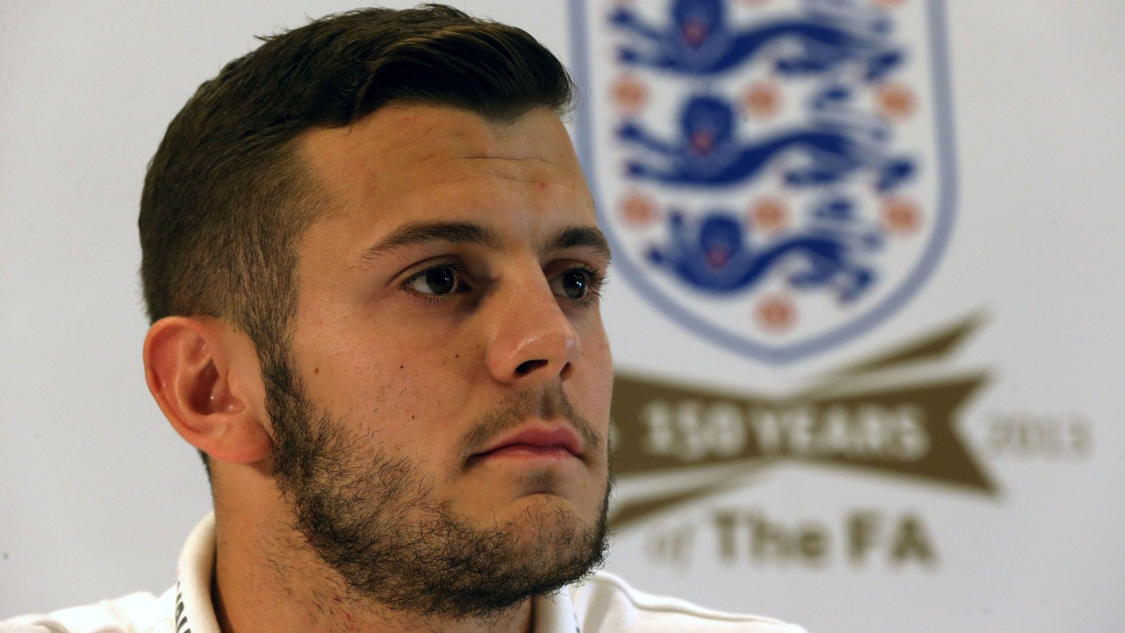 England star Jack Wilshere looks towards reporters