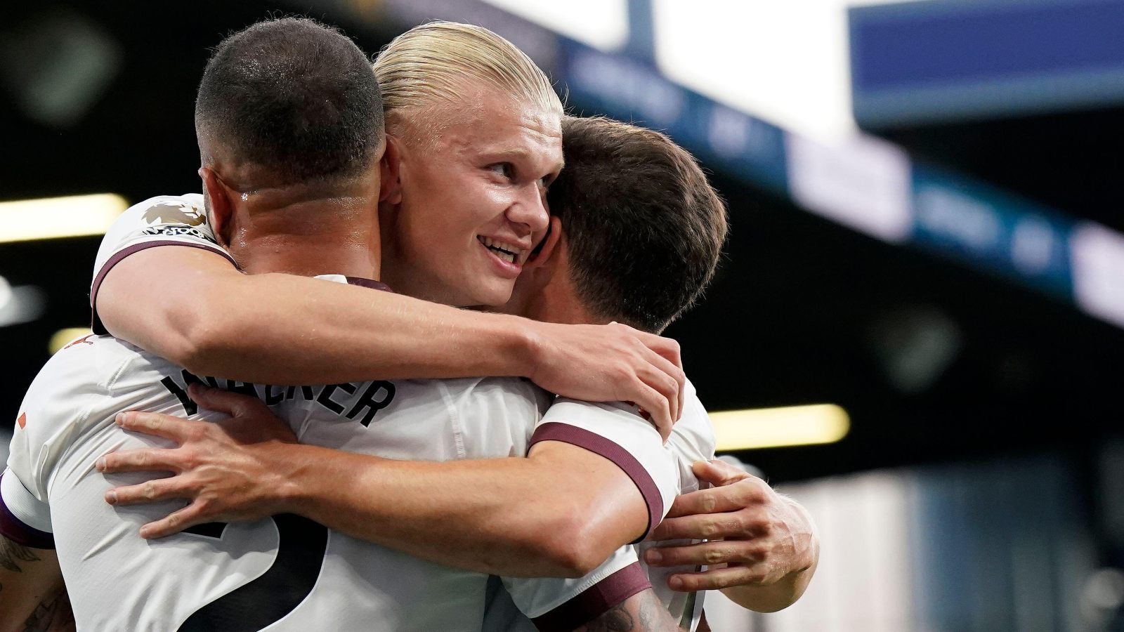 Erling Haaland celebrates his goal with Kyle Walker and Julian Alvarez.