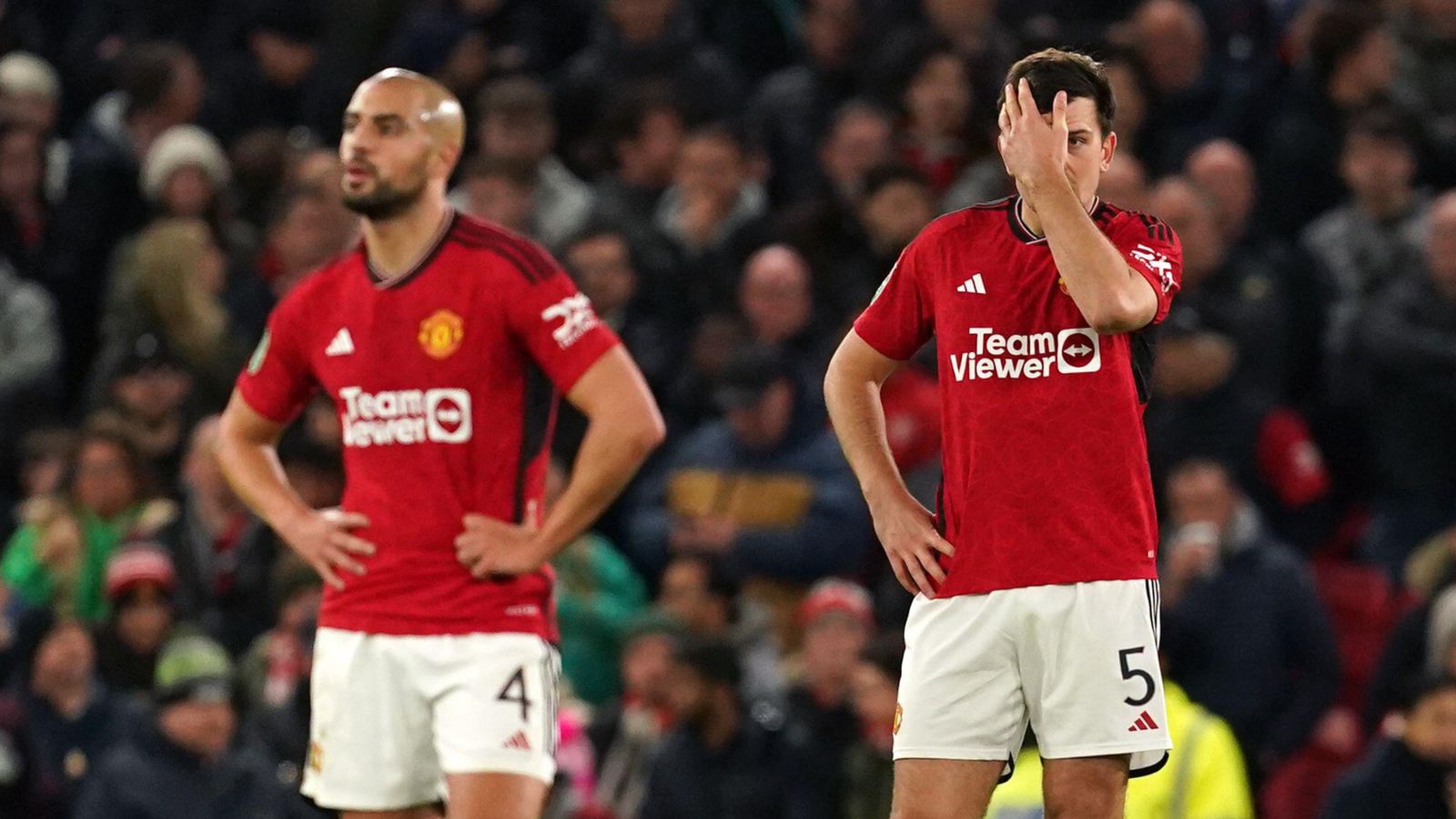 Manchester United players Harry Maguire and Sofyan Amrabat look dejected after conceding a goal.