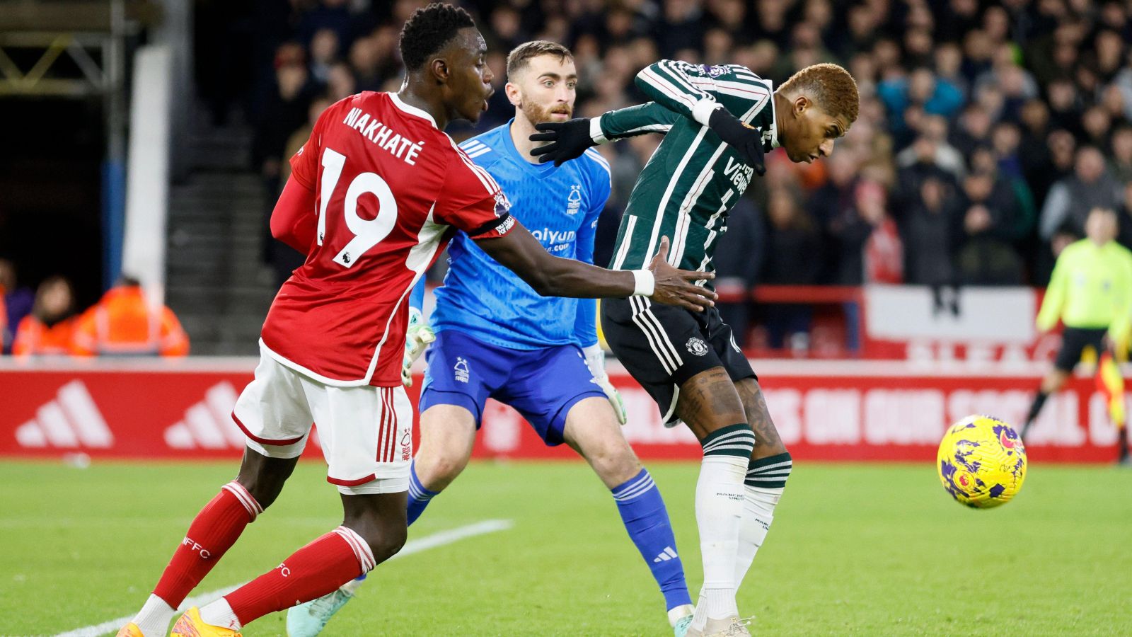 Matt Turner and Moussa Niakhate defend against Marcus Rashford.