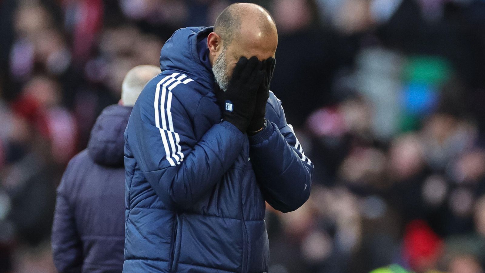 Nuno Espirito Santo holds his face in his hands.