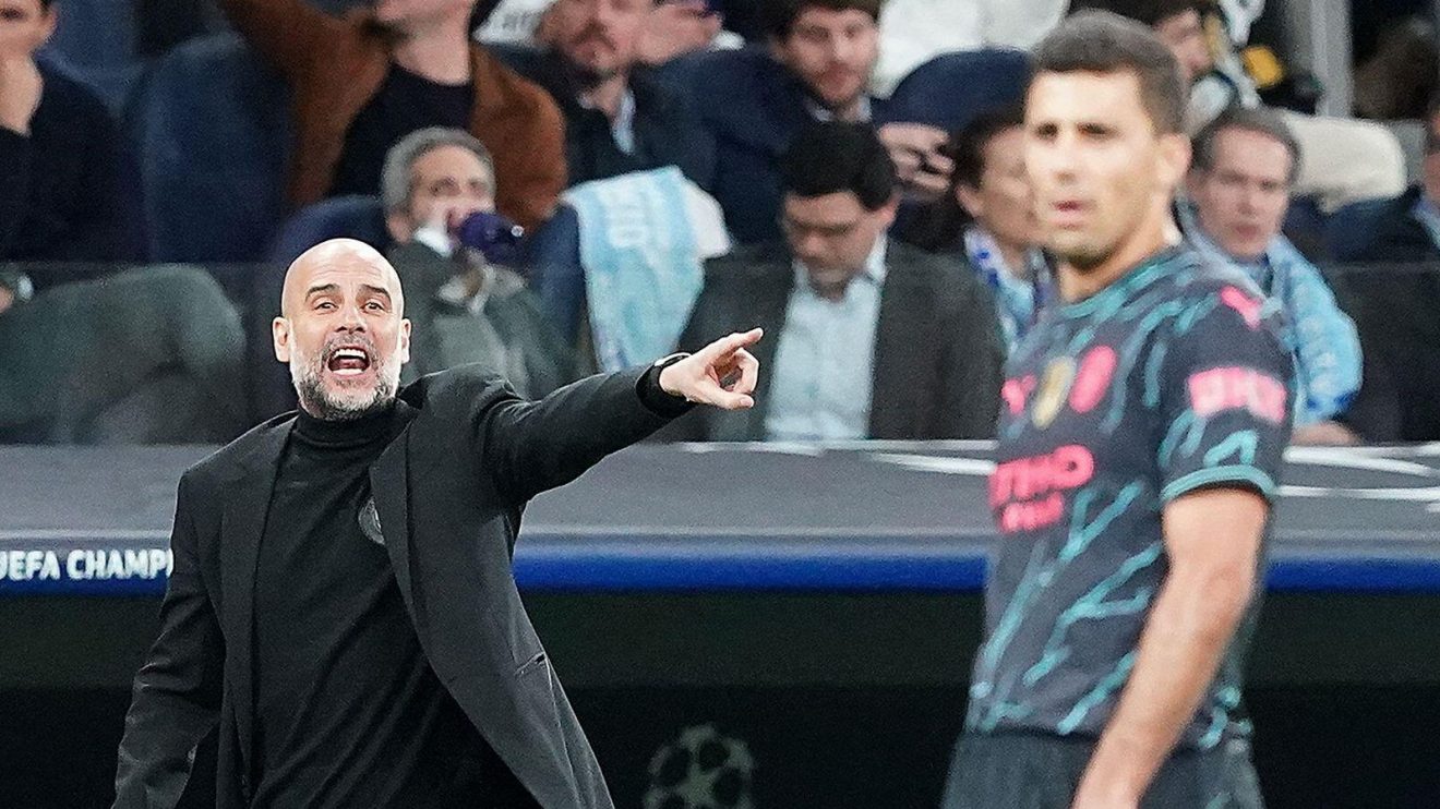 Manchester City manager Pep Guardiola and midfielder Rodri