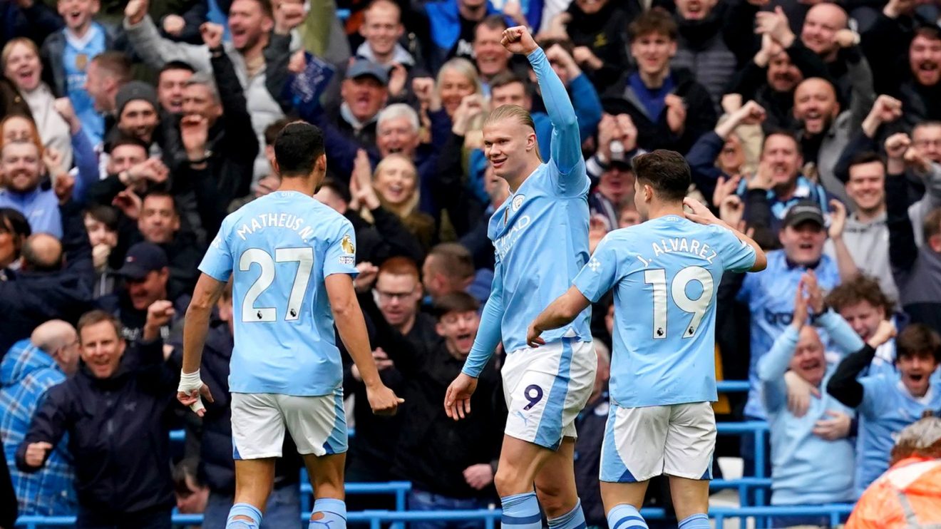 Manchester City players celebrate an early goal against Luton