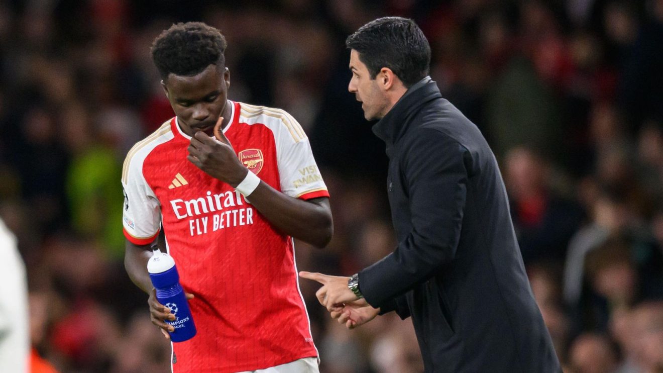 Arsenal player Bukayo Saka and manager Mikel Arteta