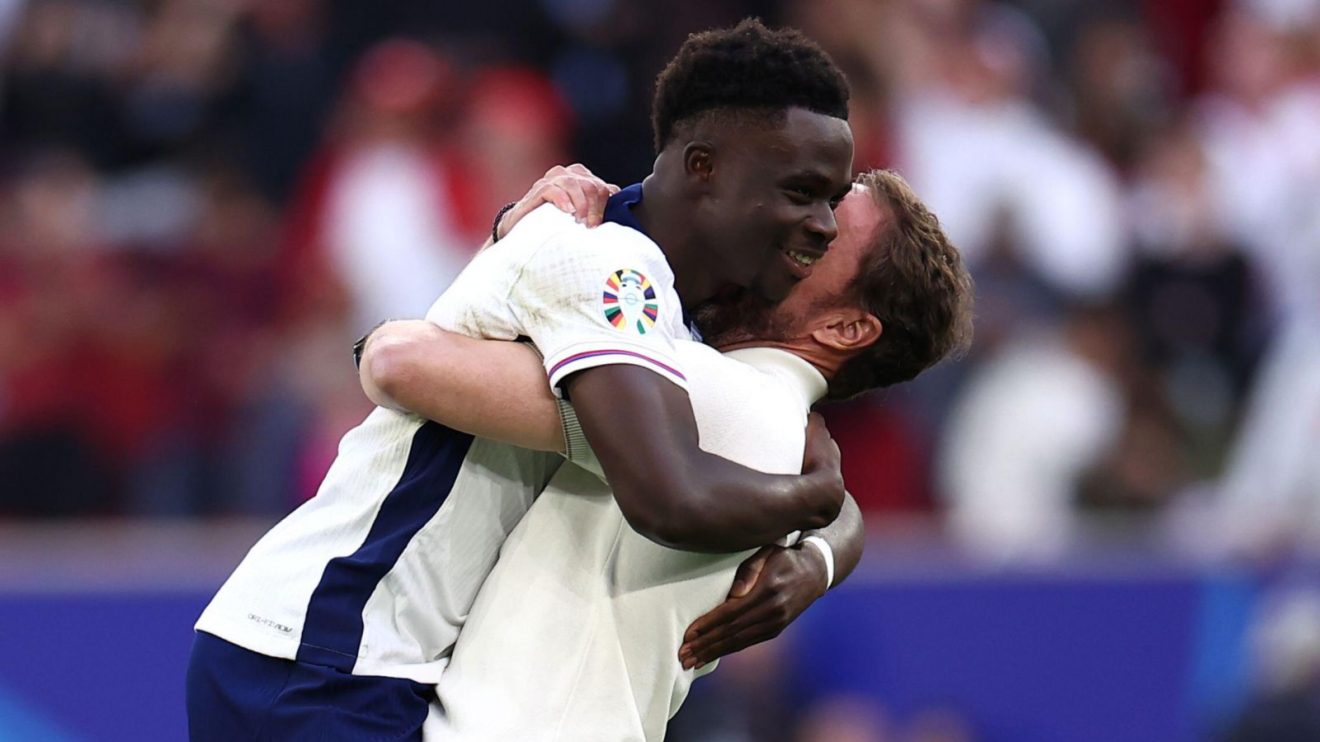 England player Bukayo Saka celebrates with manager Gareth Southgate