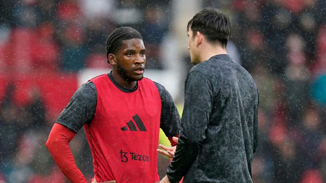 Willy Kambwala of Manchester United talks with Harry Maguire
