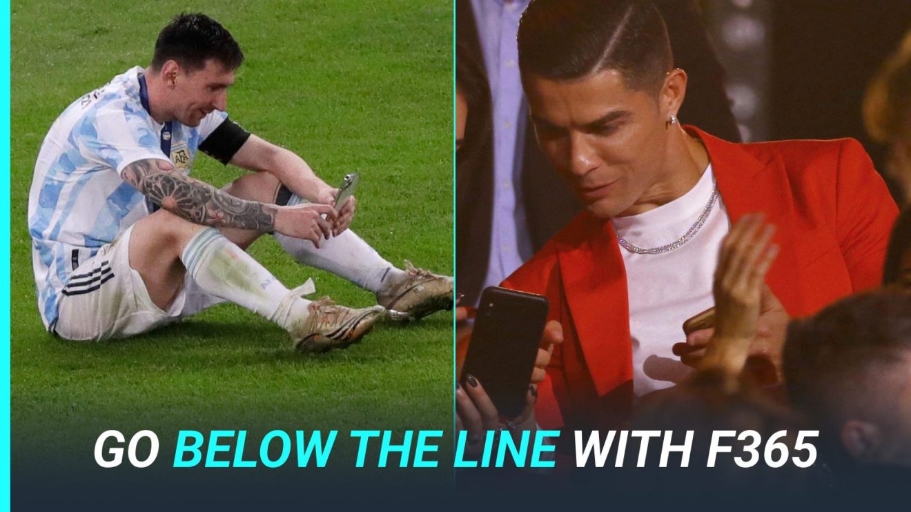 Lionel Messi and Cristiano Ronaldo look at mobile phones.
