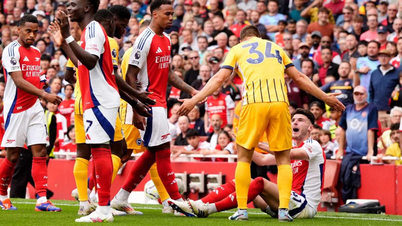 Arsenal midfielder Declan Rice sits down after being kicked by Joel Veltman