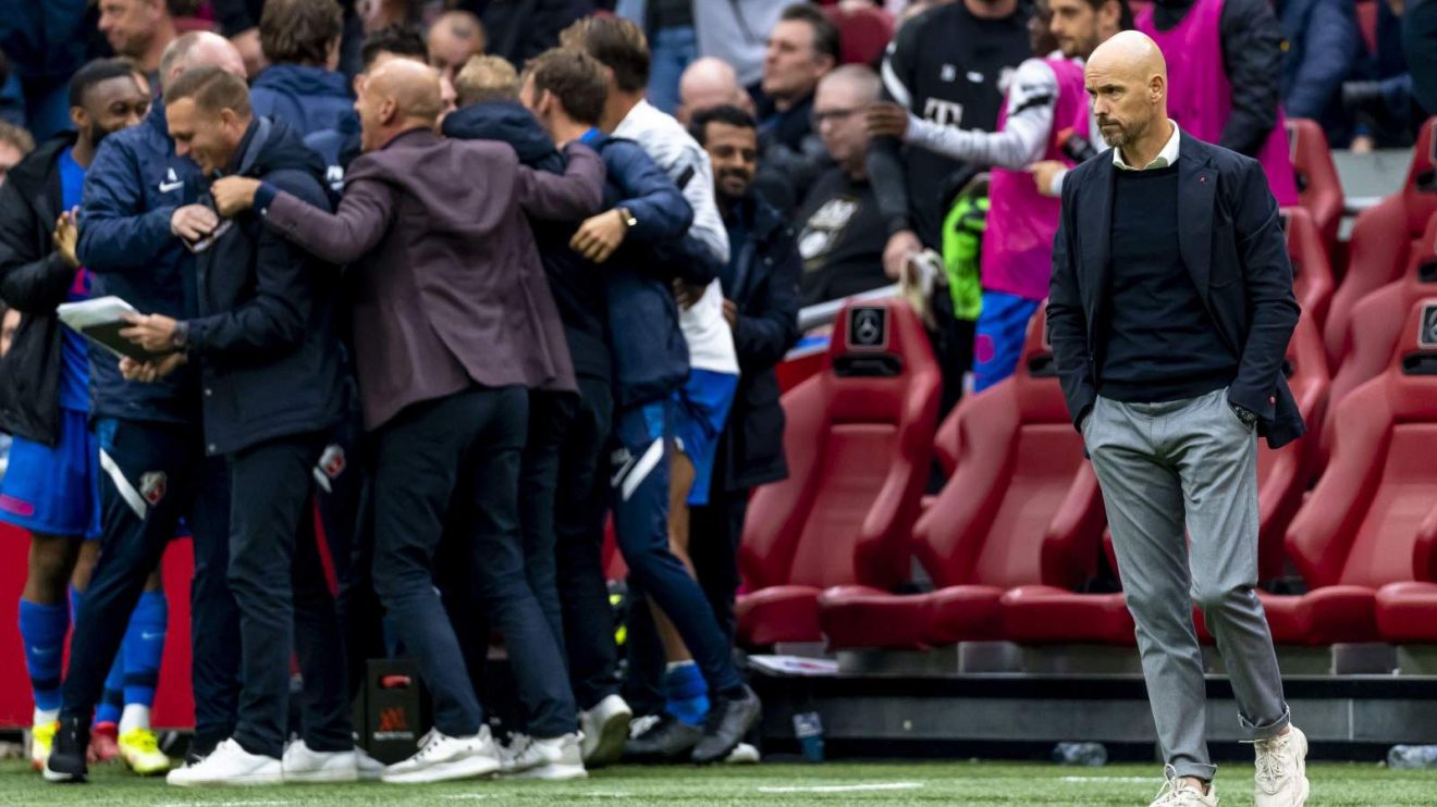Man Utd manager Erik ten Hag looks dejected as a team celebrates