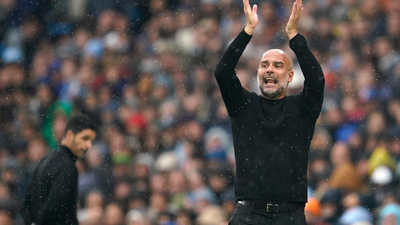 Pep Guardiola applauds as an unhappy-looking Mikel Arteta is seen in the background