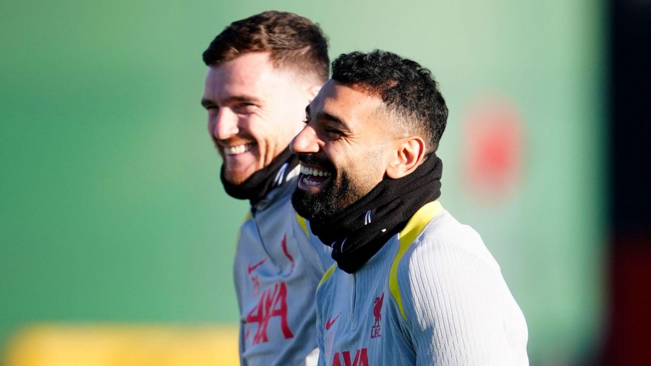Liverpool players Andy Robertson and Mo Salah laugh in training