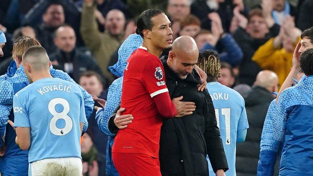 Liverpool defender Virgil van Dijk embraces Manchester City manager Pep Guardiola