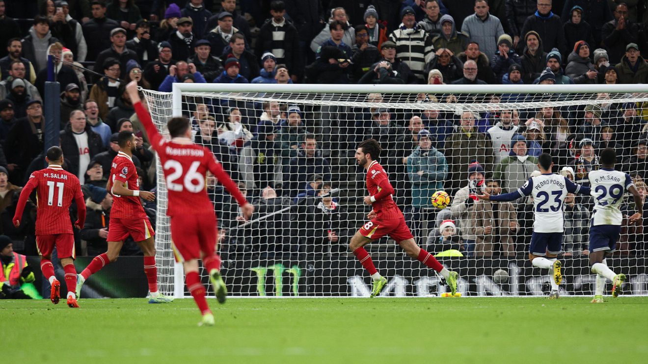 Dominik Szoboszlai wheels away to celebrate Liverpool's third goal against Tottenham, with teammates celebrating and Spurs plays looking dejected as the ball hits the net