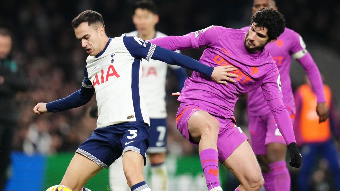 Spurs player Sergio Reguilon competes for the ball against Wolves forward Goncalo Guedes