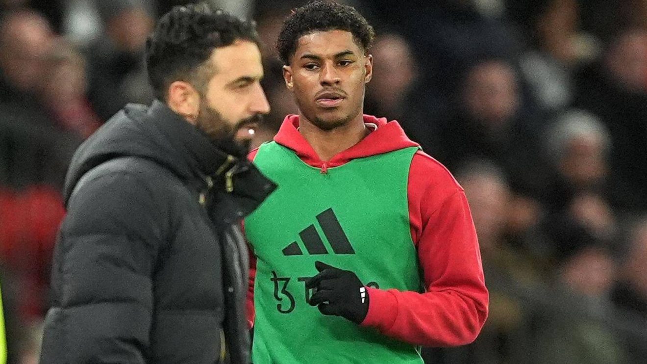 Man Utd winger Marcus Rashford warms up behind Ruben Amorim