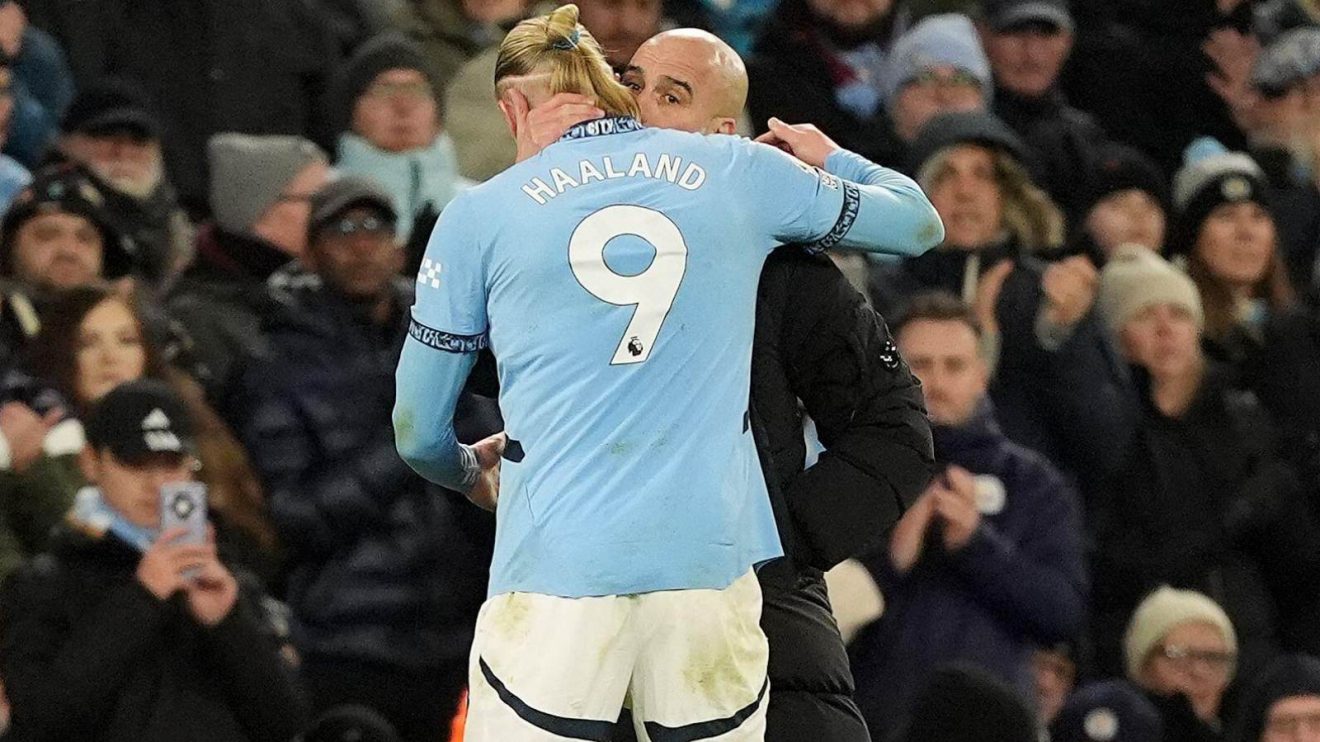 Man City manager Pep Guardiola hugs Erling Haaland