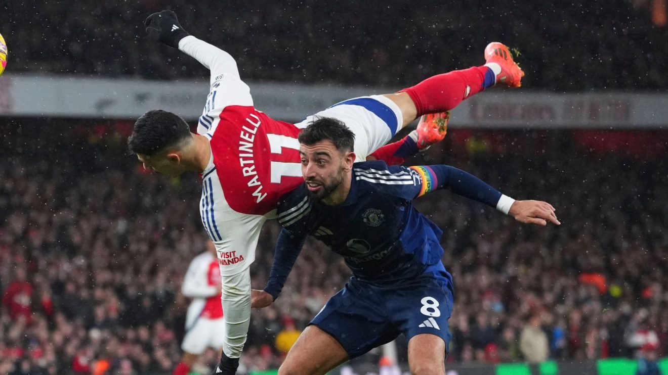 Arsenal forward Gabriel Martinelli and Manchester United player Bruno Fernandes compete for a header