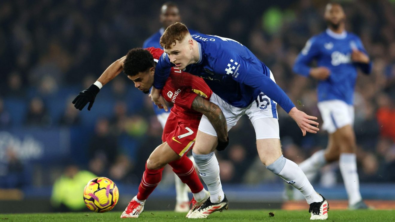 Everton and Liverpool battle for the ball