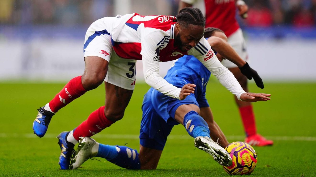 Arsenal winger Raheem Sterling is challenged during a match