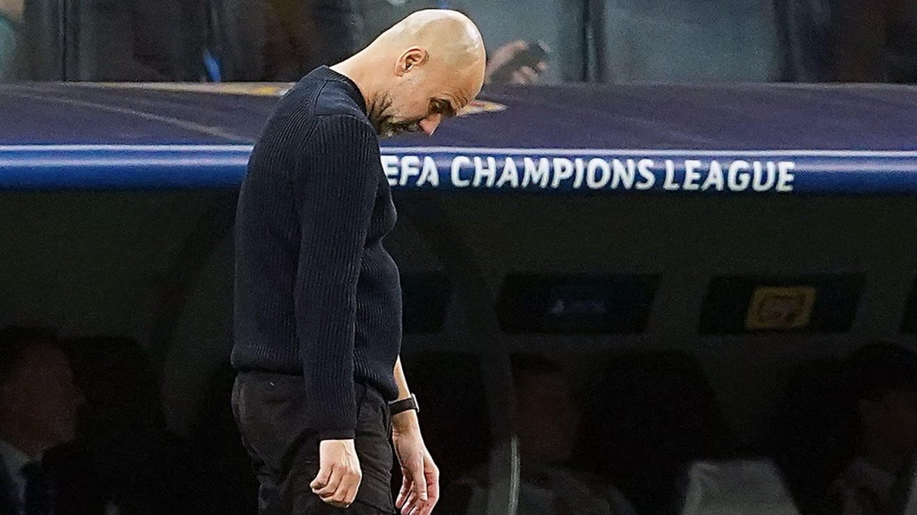 Pep Guardiola looks dejected.
