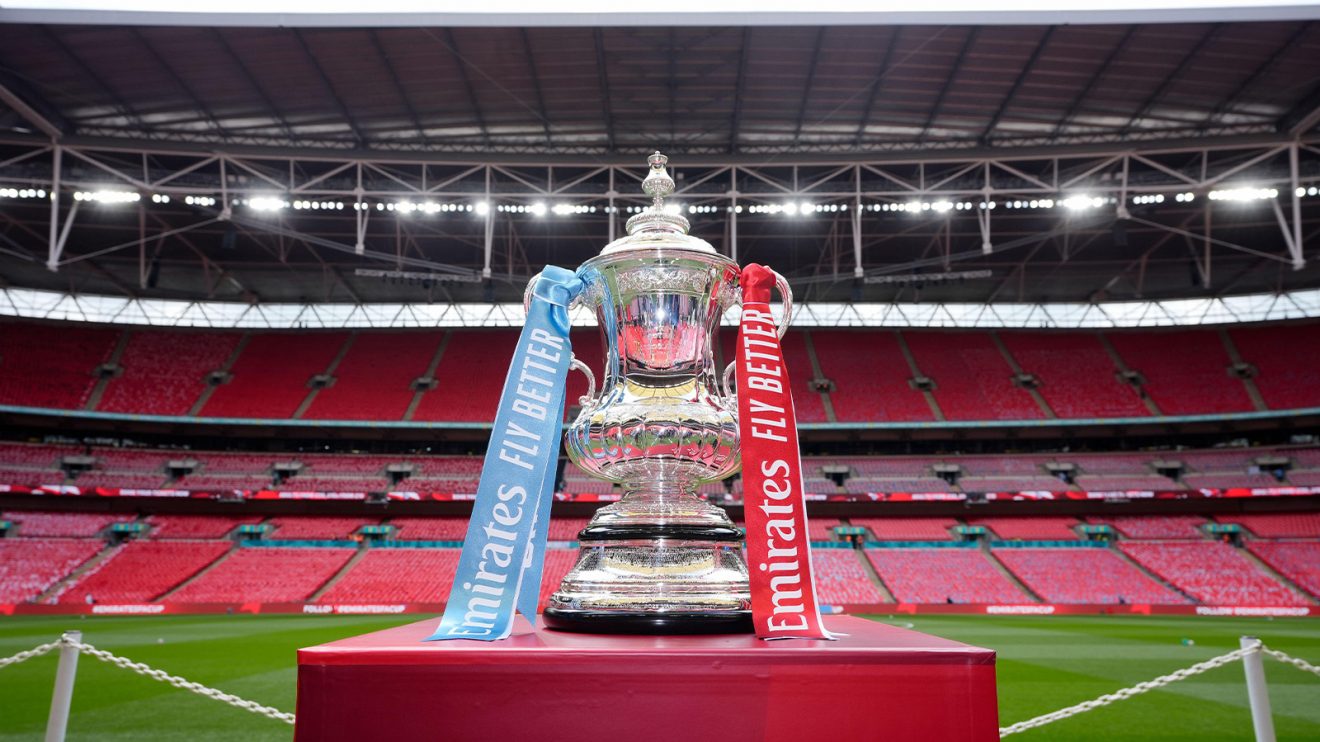 The FA Cup on a plinth at an empty Wembley stadium