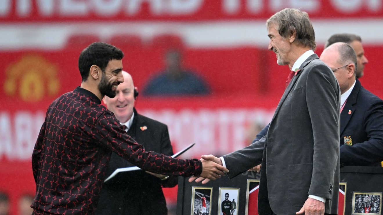 Manchester United player Bruno Fernandes shakes hands with co-owner Sir Jim Ratcliffe