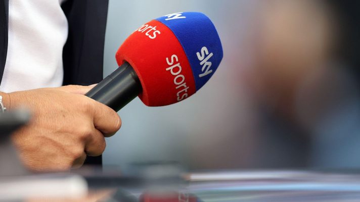 An unknown Sky Sports pundit holds a microphone