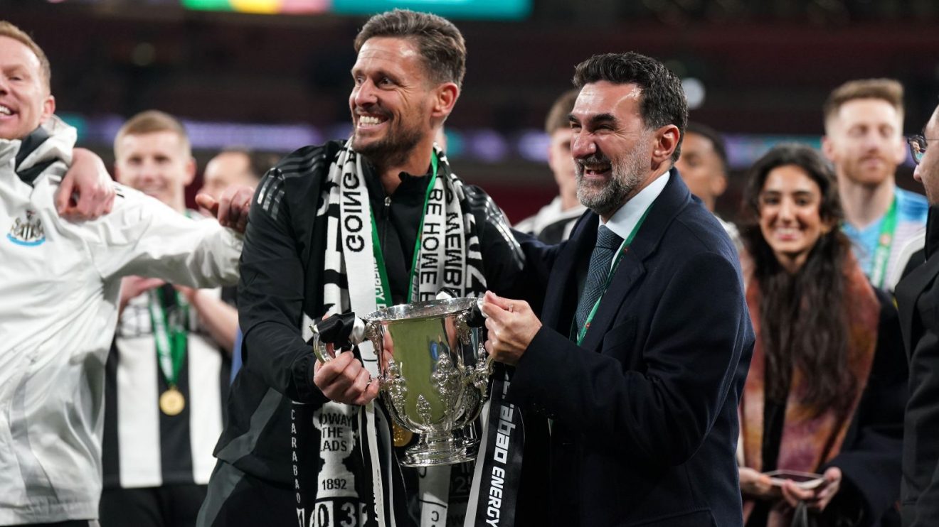 Newcastle assistant Jason Tindall and chairman Yasir Al-Rumayyan with the Carabao Cup trophy