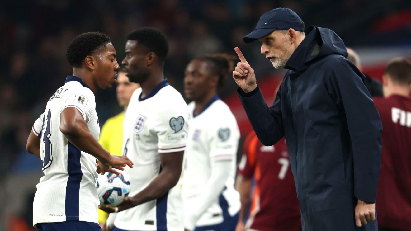 England player Myles Lewis-Skelly receives instructions from coach Thomas Tuchel
