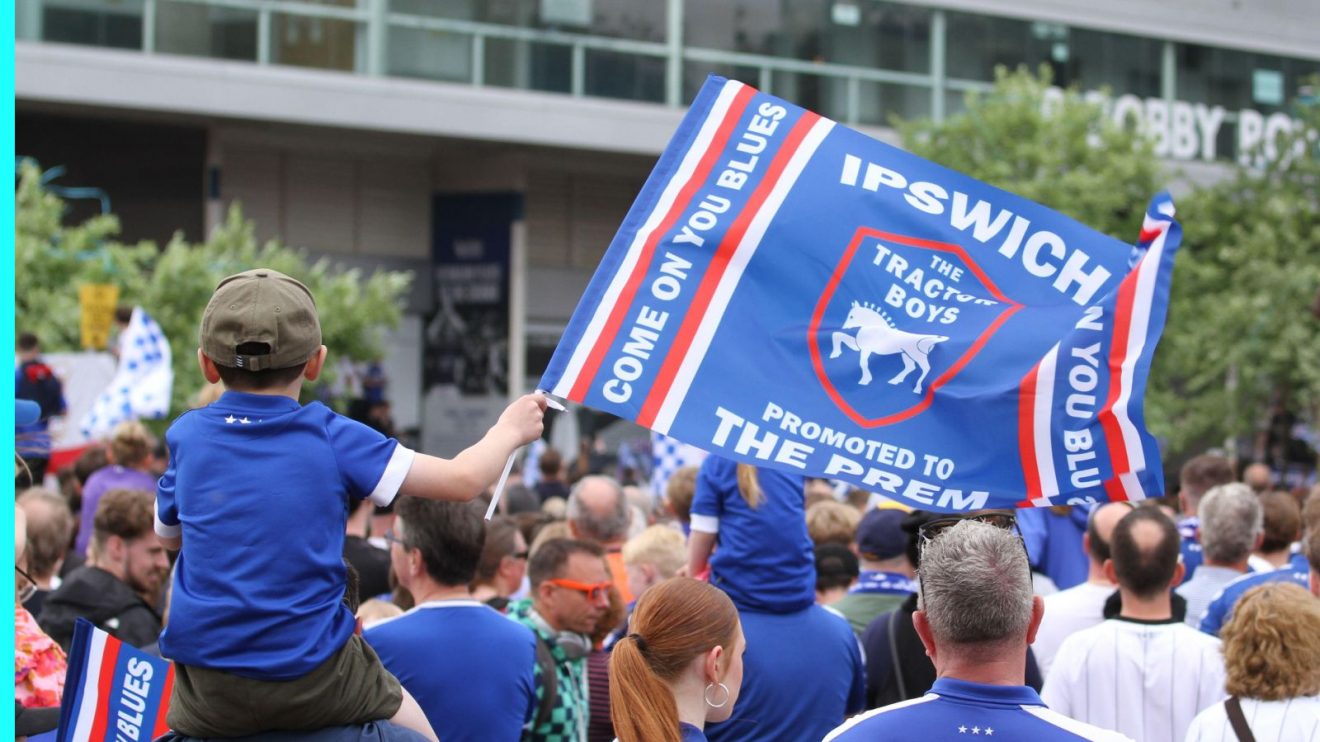 An Ipswich fan with a flag celebrating promotion.