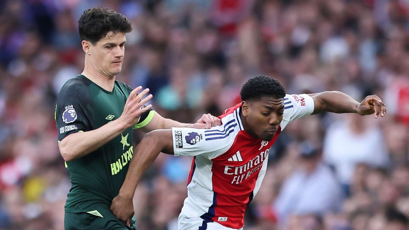 Brentford player Christian Norgaard challenges Arsenal defender Myles Lewis-Skelly