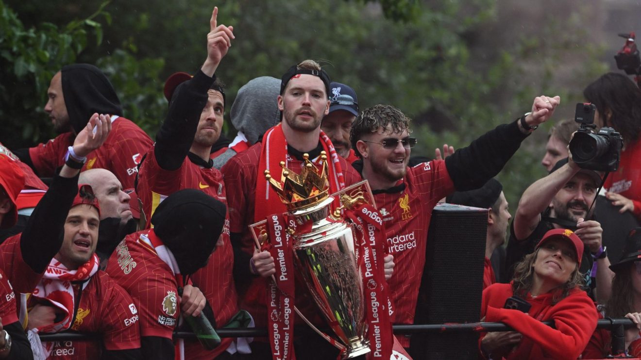 Liverpool players including Caoimhin Kelleher celebrate with the Premier League trophy