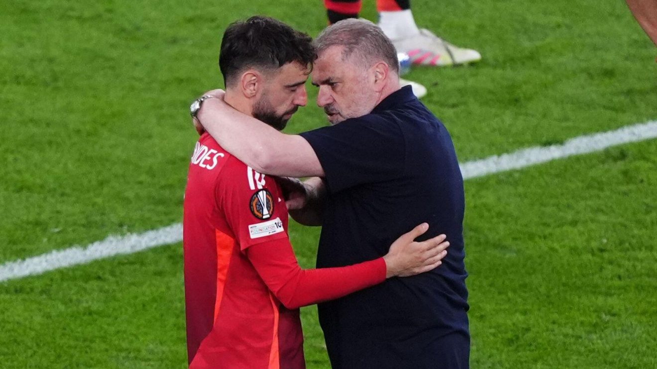 Manchester United player Bruno Fernandes is consoled by Spurs manager Ange Postecoglou