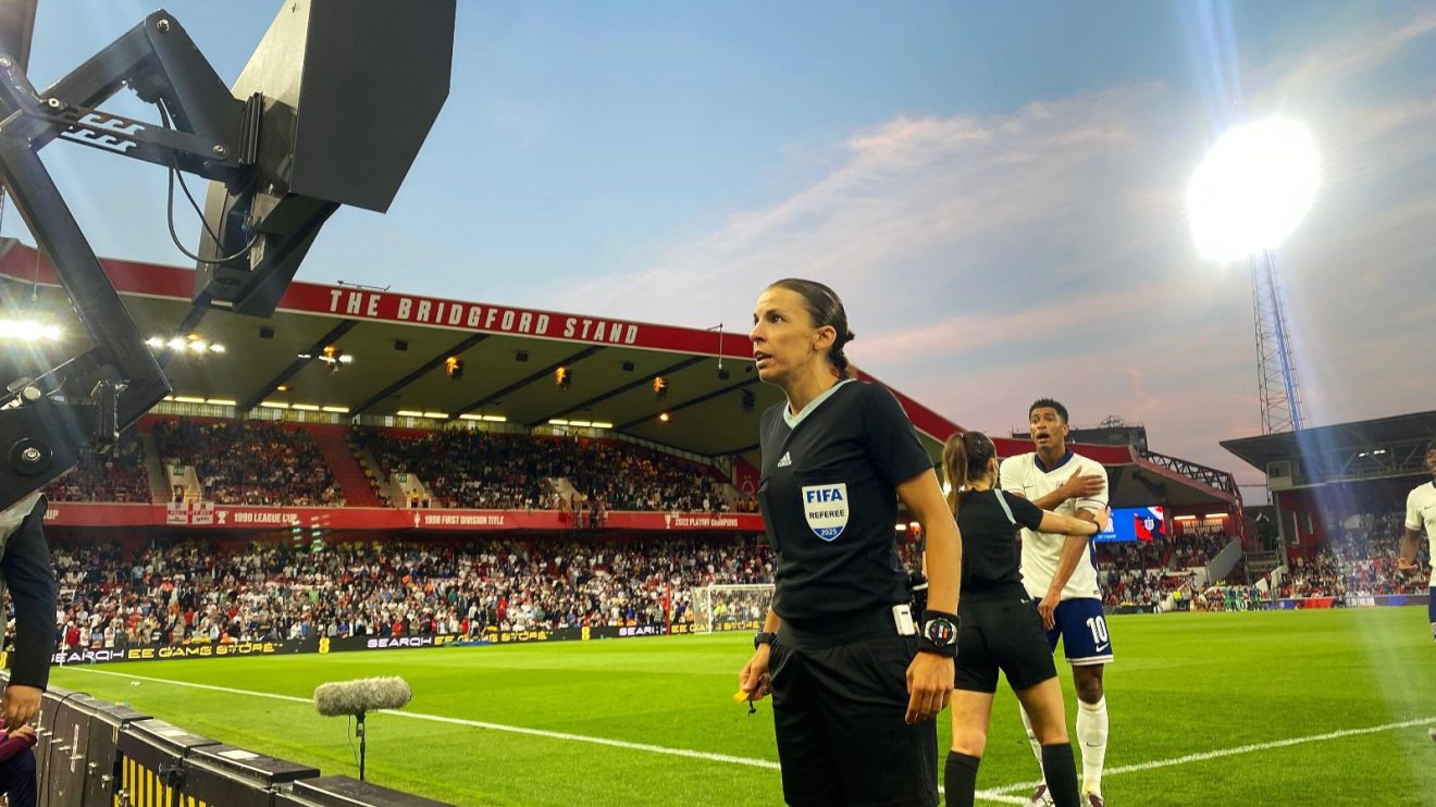 Stephanie Frappart checks the monitor as England player Jude Bellingham protests