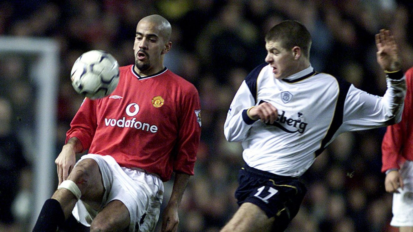 Man Utd midfielder Juan Sebastian Veron takes on Liverpool player Steven Gerrard