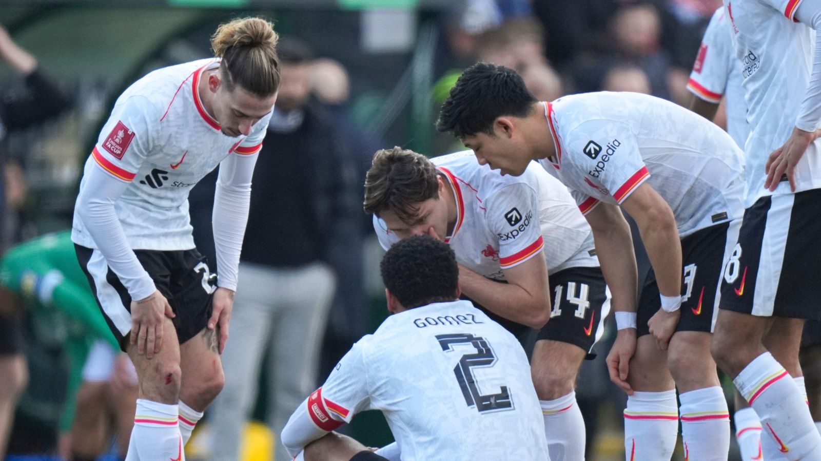 Liverpool players surround Joe Gomez after the defender suffers an injury