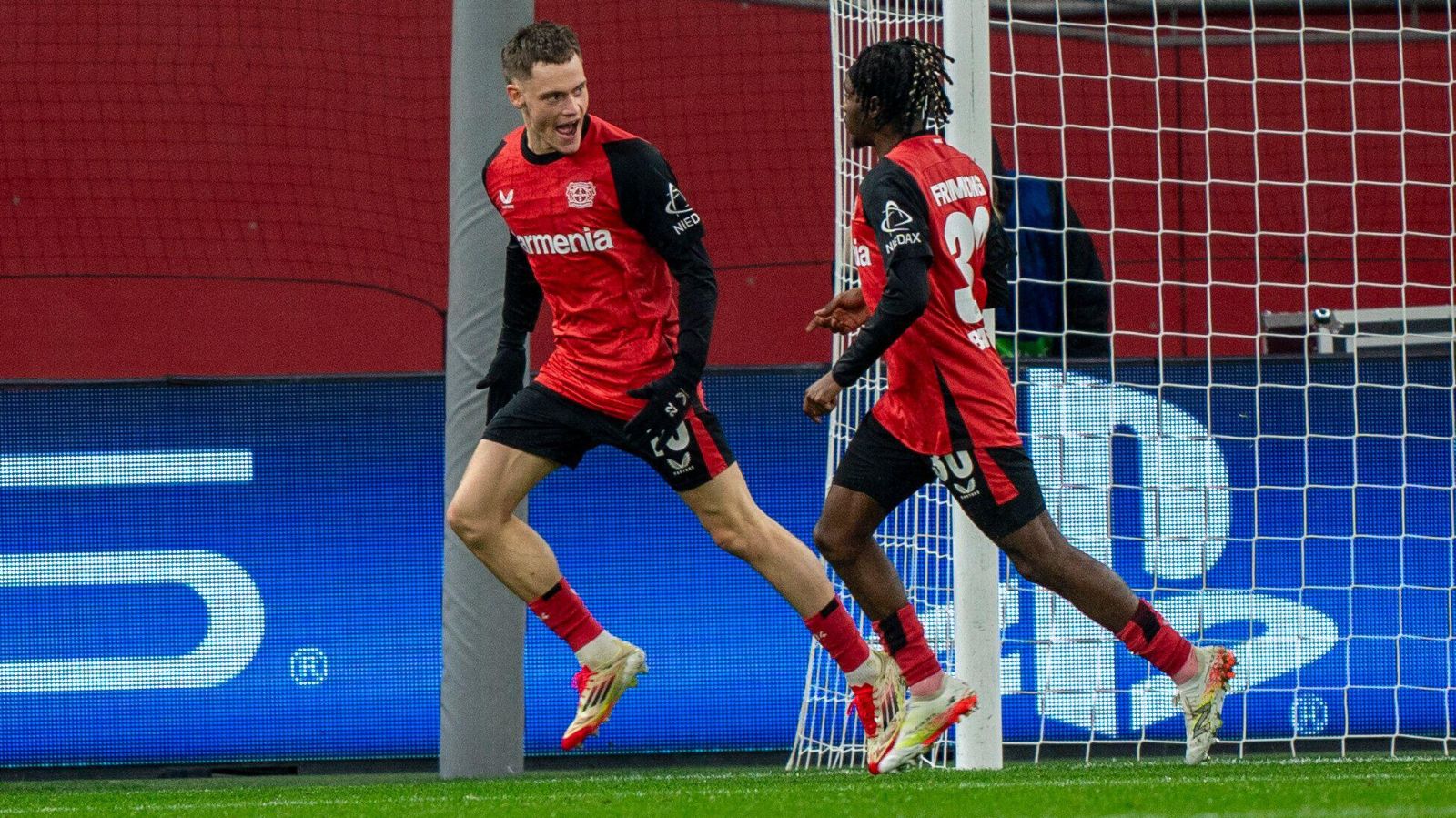 Bayer Leverkusen players Florian Wirtz and Jeremie Frimpong celebrate before moving to Liverpool