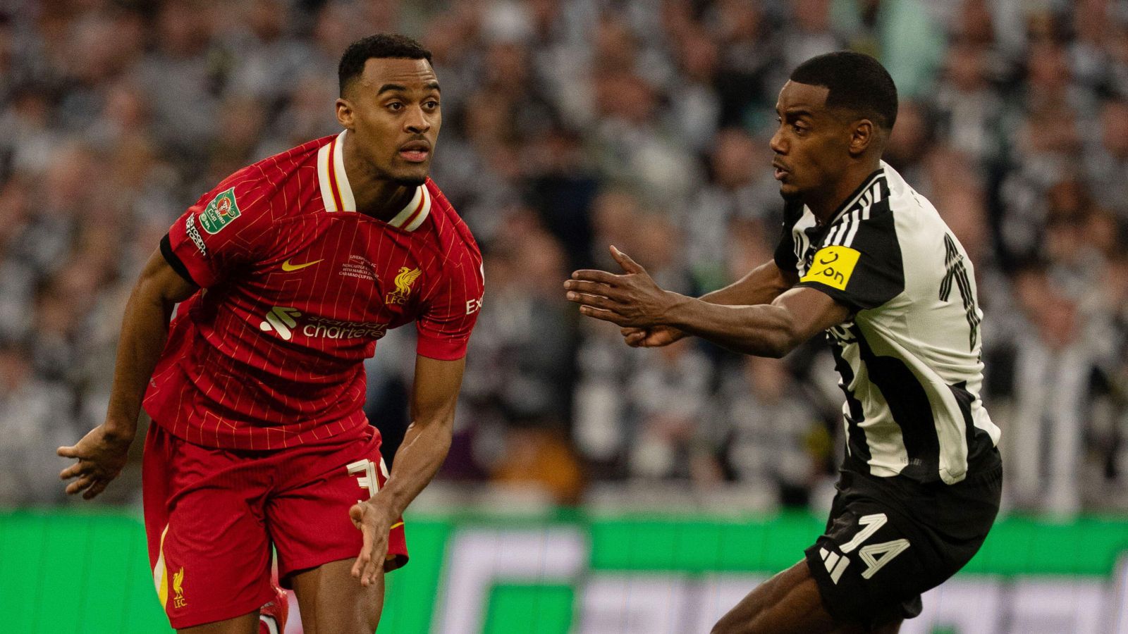 Liverpool midfielder Ryan Gravenberch tries to dribble past Newcastle forward Alexander Isak