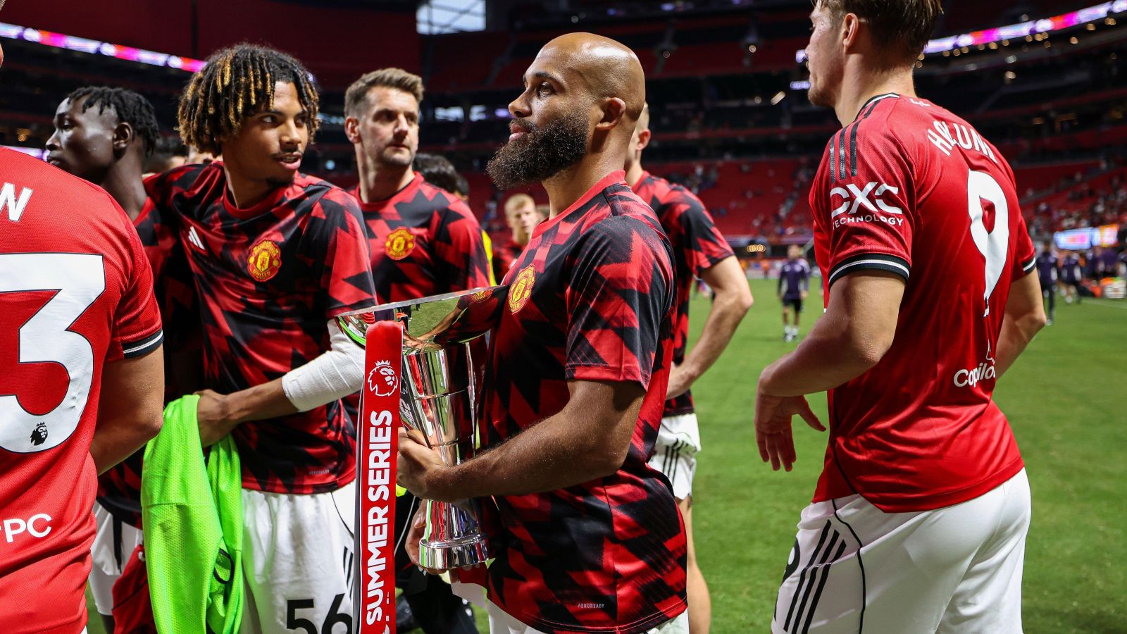 Manchester United players celebrate with the Premier League Summer Series trophy