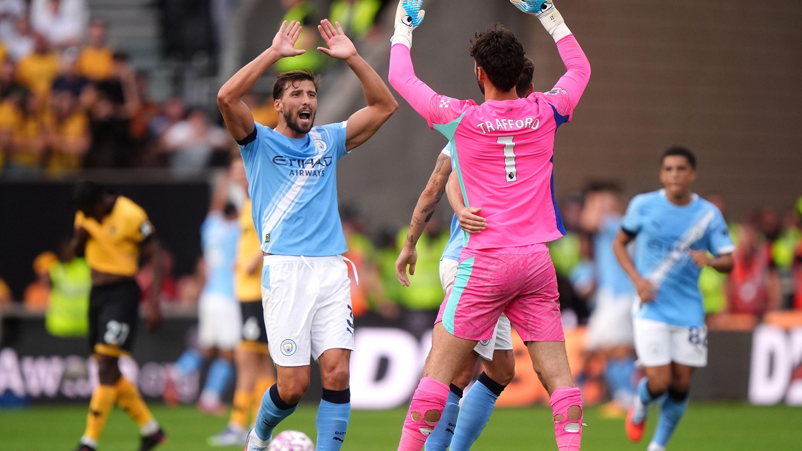 Ruben Dias high fives Man City goalkeeper James Trafford