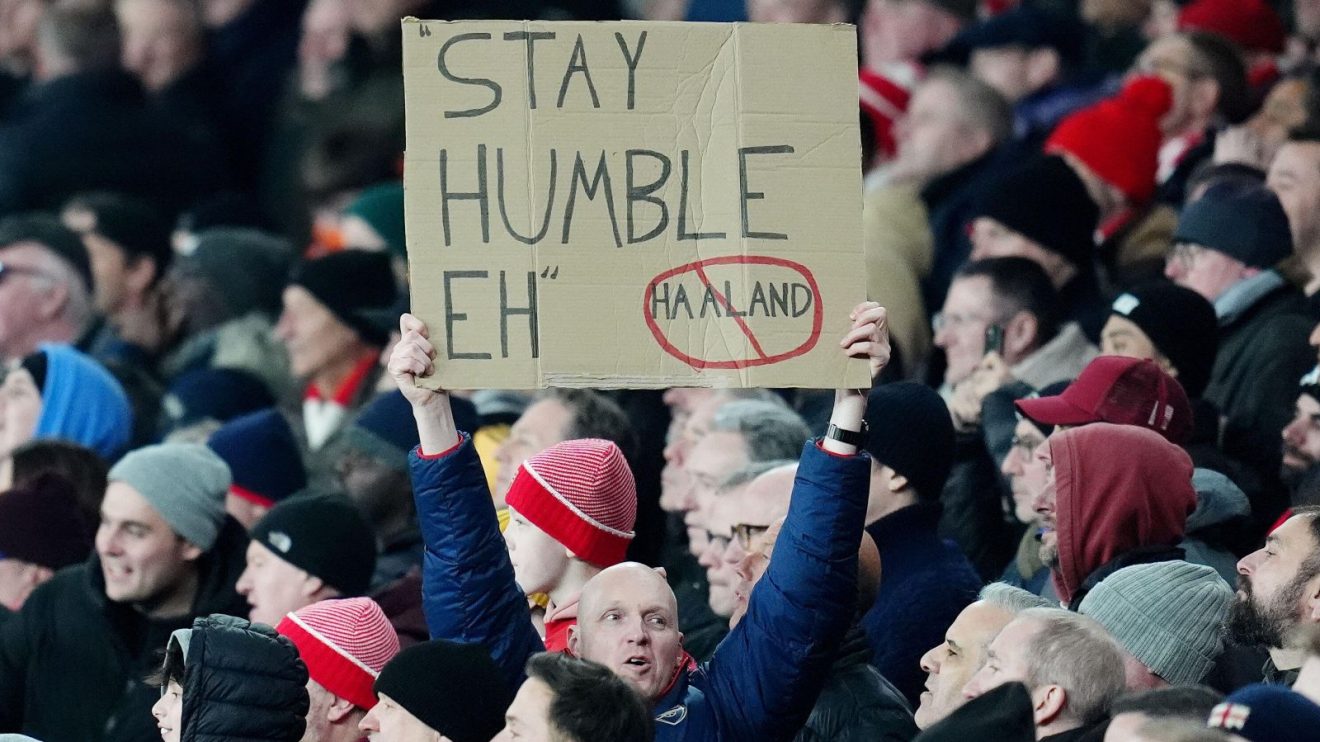 An Arsenal supporter mocks Manchester City forward Erling Haaland