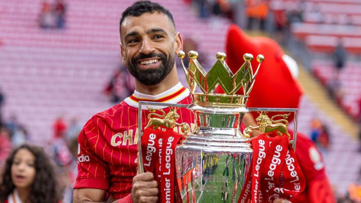 Liverpool winger Mohamed Salah holds the Premier League trophy