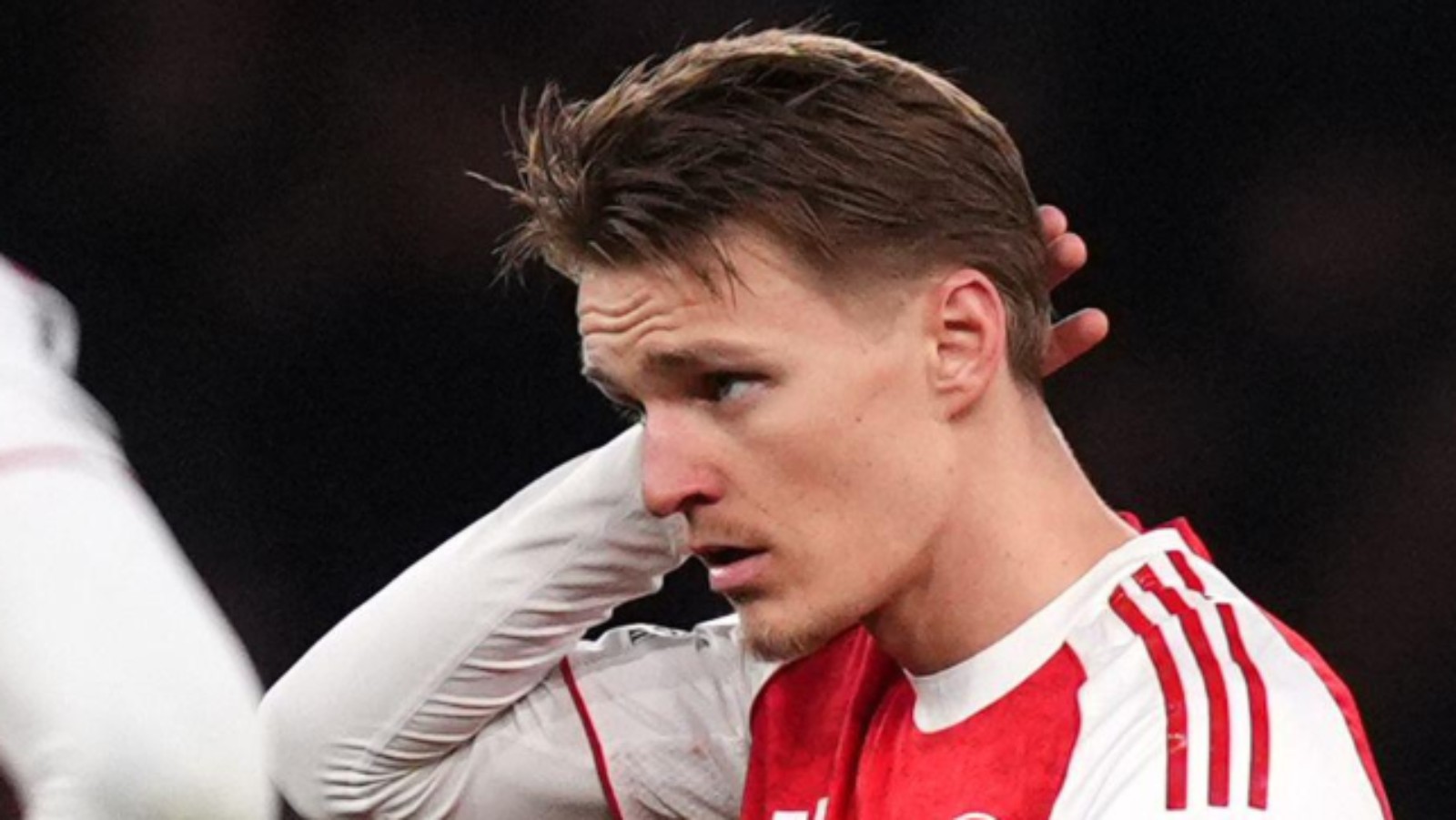 Arsenal player Martin Odegaard dejected after being beaten by Manchester United