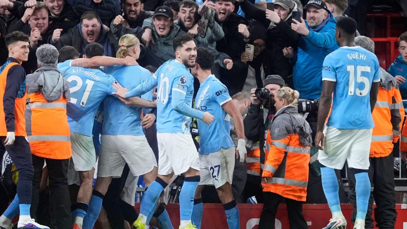 Man City players celebrate their goal against Liverpool