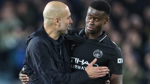 Man City manager Pep Guardiola embraces Marc Guehi