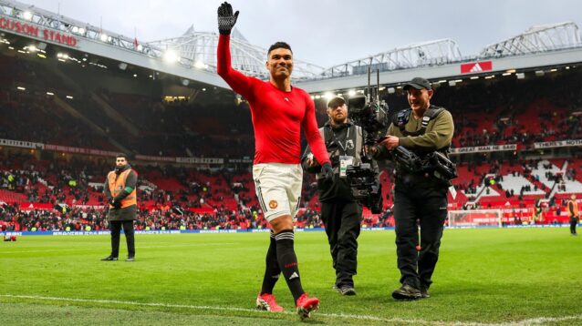 Casemiro leaves the pitch while wave to Man Utd fans.