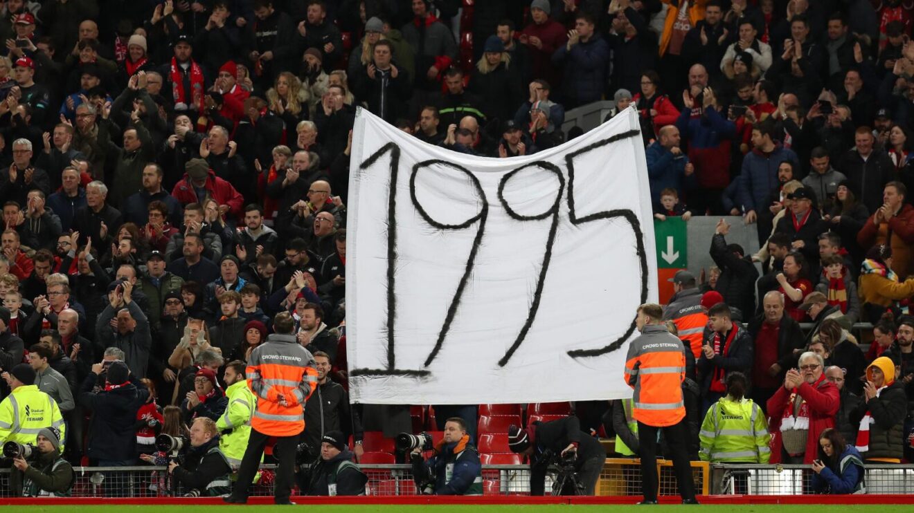 Liverpool fans mock Everton fans with a 1995 banner to highlight the Toffees' last trophy win