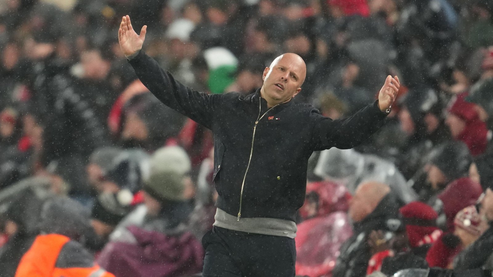 Arne Slot flings his arms in the air