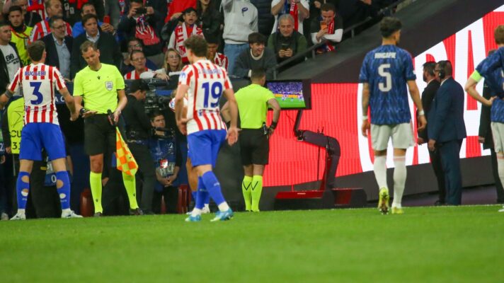 Referee Danny Makkelie consults the monitor before overturning an Arsenal penalty against Atletico Madrid